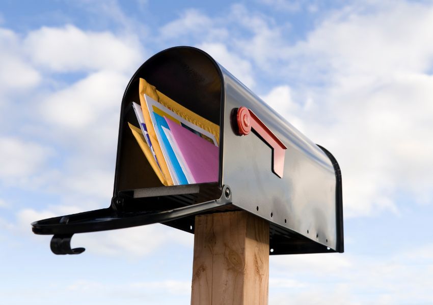 letters varying in size inside a black, open mailbox